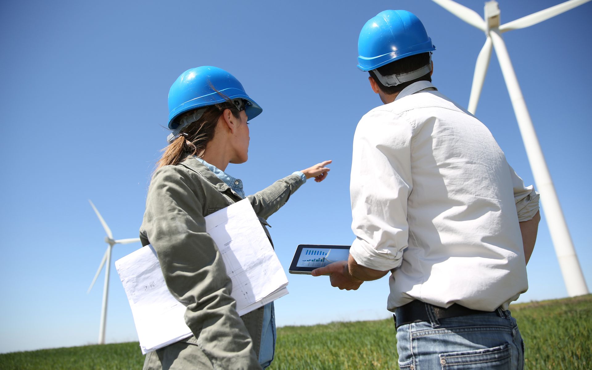 Engineers,Looking,At,Wind,Turbine,Site,With,Tablet